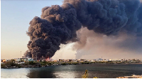 A large plume of smoke rises from a fuel depot in Port Sudan, Sudan, on May 6