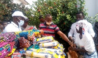 Nana Nkansa Boadu Ayeboafo presenting some items to the needy