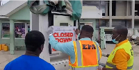 A file photo of EPA officials shutting down a fuel station