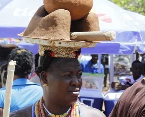 Woman carries stove made from clay at Hogbetsotso festival