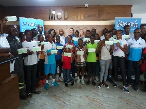 The recipients and Macdan  and other officials displaying their cheques after receiving it.