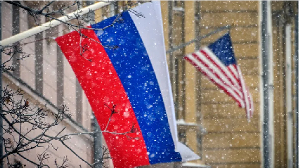 A Russian flag flies next to the US Embassy building in Moscow