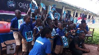 The pupils displaying their learning materials donated to them by OLAF