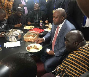 Former President Mahama pictured with a spoon in a plate of rice with a number of the Minority MP's