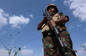 A member of Houthi security forces stands guard during a rally in Yemen's capital, Sanaa