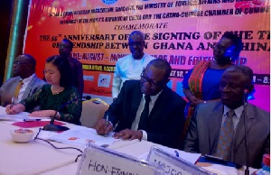 Emmanuel Bombande (2nd right) and Sun Baoyong signing the treaty again