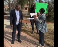An official of the Ghana High Commission in Canada (left) confronting a protester