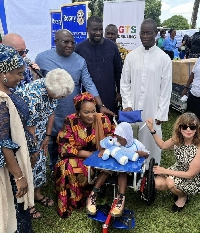 Her Excellency Samira Bawumia (centre) with a wheelchair recipient Elizabeth Newman on her left