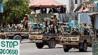 Somali security officers guard the area near the scene of an attack linked to al-Shabaab