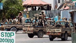 Somali security officers guard the area near the scene of an attack linked to al-Shabaab