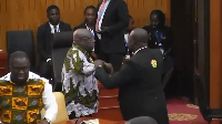 Sefwi Wiawso MP Dr Kwaku Afriyie being held by the marshal