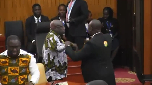 Sefwi Wiawso MP Dr Kwaku Afriyie being held by the marshal