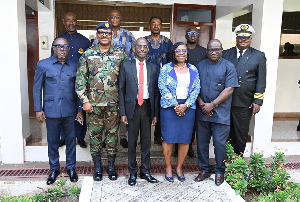 Asiedu Nketiah in black suit and red tie alongside other board members