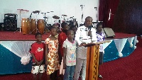 Adu-Sarkodie with some kids delivering his address on Father