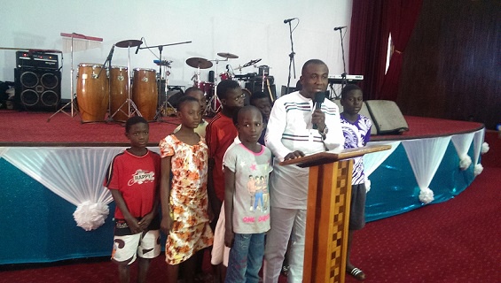 Adu-Sarkodie with some kids delivering his address on Father
