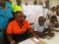 Nana Kwasi Prempeh, Chairman of the Kumasi Petty Traders Association (In orange shirt)