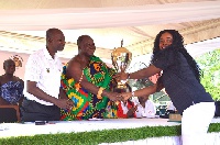 Asantehene Otumfuo Osei Tutu II giving the trophy to one of the winners