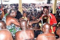 Captain Amos Frimpong presents the trophy to the Asantehene.