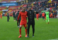 Bernard Mensah celebrates with Gyan after the game