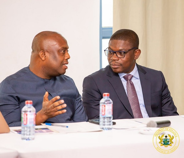 Deputy Minister for Finance, Thomas Nyarko Ampem (Left) in a chat with Richard Gyan-Mensah
