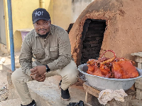Etsey Atisu poses for a picture beside some freshly baked 'domedo'