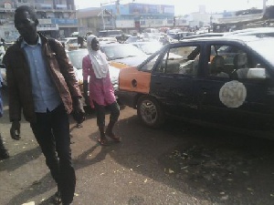 Stranded passengers and some parked taxis in Tamale