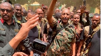 Army chief Abdel Fattah al-Burhan (C) cheering with soldiers