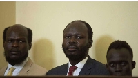 South Sudan activist Peter Biar Ajak (C) looks on during his first appearance before the judiciaryci