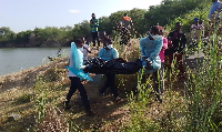 The bodies being conveyed from the scene