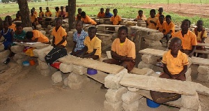 In some communities, school children sit under trees