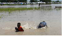 Children seen swimming in floods