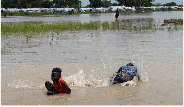 Children seen swimming in floods