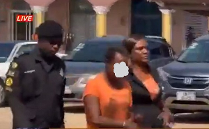The suspected kidnapper, Helena Oduro, being led to the court by police.