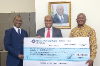 Officials of Sahel Sahara Bank handing over the dummy cheque to Mr Amankwah (right)