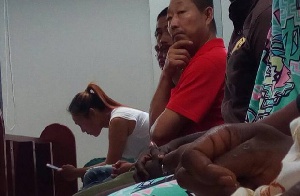 Aisha Huang (with her phone) in court