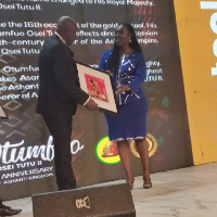 Ursula Owusu-Ekuful on the right receives the plaque on behalf of Naa Torshie