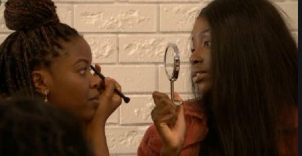 A black girl checking out her make-up