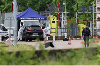 A forensics team inspects the site of a prison convoy ambush in France on Tuesday