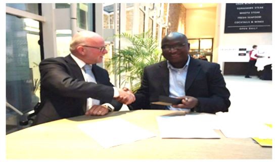 Mr. Nelson Agyei CEO of Hallmark Oil in a handshake with Mr. Rene Huting, Area Business Manager