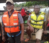 Some members of the Nzema East Municipal Assembly helping with the evacuation of  trapped residents
