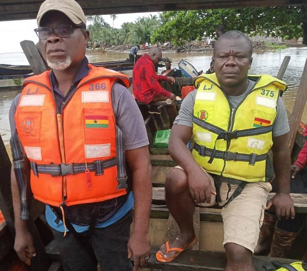 Some members of the Nzema East Municipal Assembly helping with the evacuation of  trapped residents