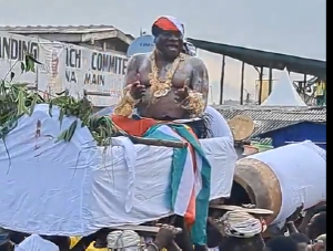 The chief is seen wearing NDC colours and a branded scarf tied around his head