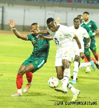 Patrick Kpodzo being tackled by Madagascar player