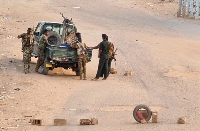 Sudanese army soldiers on a road blocked with bricks in Khartoum on May 20, 2023 [AFP]