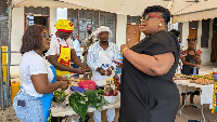 MCE for Adentan, Ella Esinam Christine Nongo (r) interacting with some exhibitors at the event