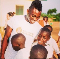 Black Stars winger, Christian Atsu with after a donation to children