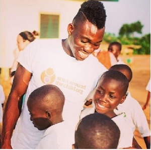 Christian Atsu sharing hugs with children
