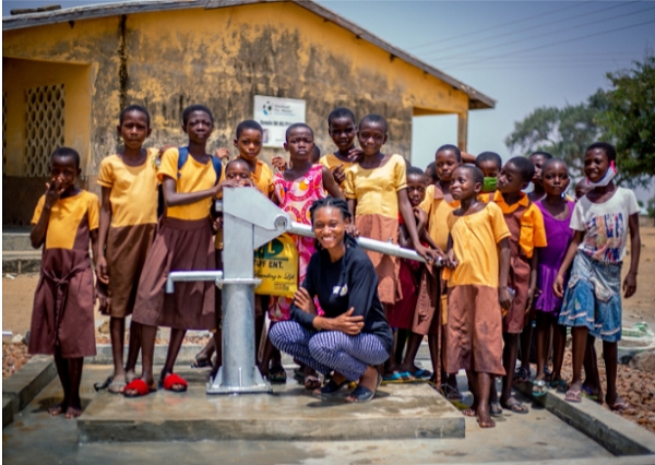 Kenndicta A-ensonga Ajene in a picture with some basic pupils