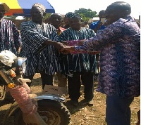 The MCE, Michael Sarkodie (R) handing over the tricycle to Thomas Mankire (L)