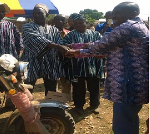 The MCE, Michael Sarkodie (R) handing over the tricycle to Thomas Mankire (L)